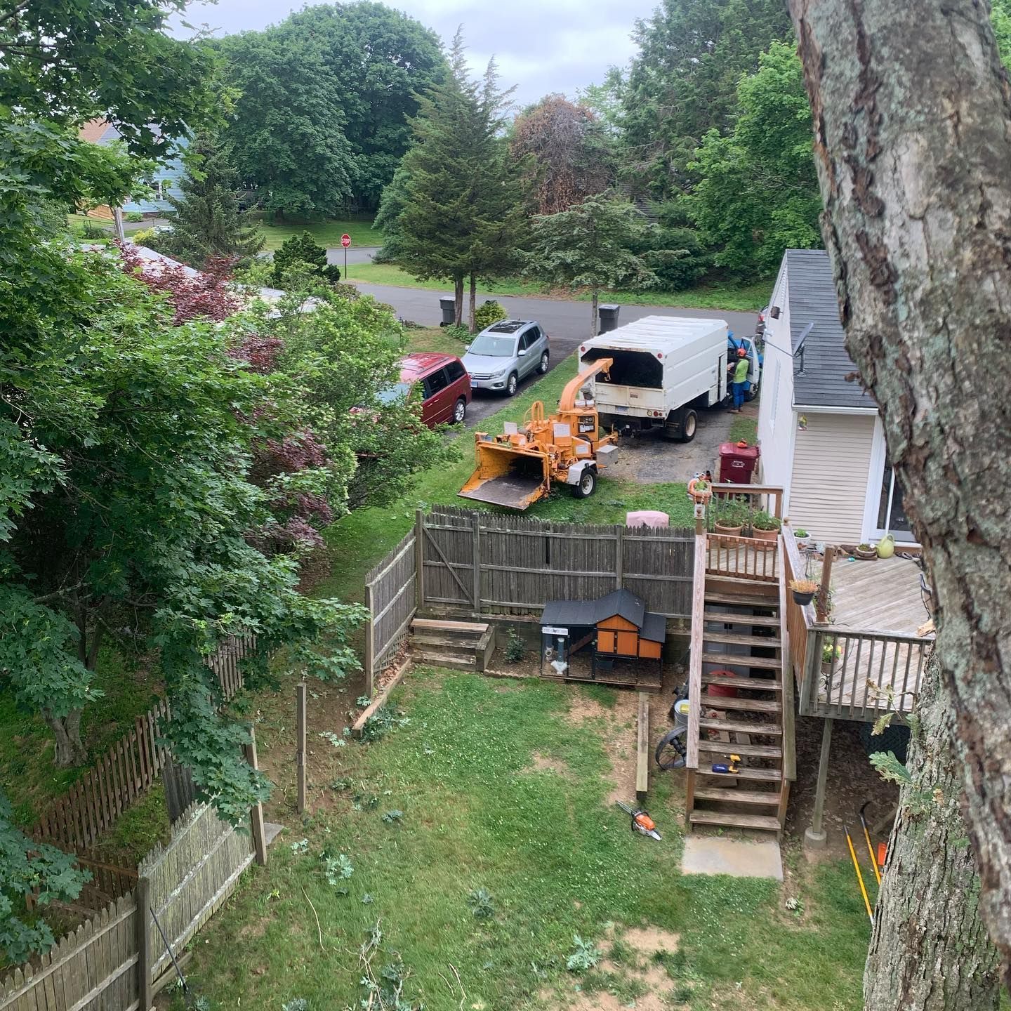 An aerial view of a backyard with a tree stump in the middle of it.
