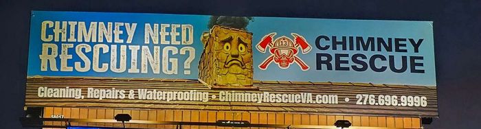 Blue Chimney Rescue truck advertising chimney cleaning and repairs with phone number and logo