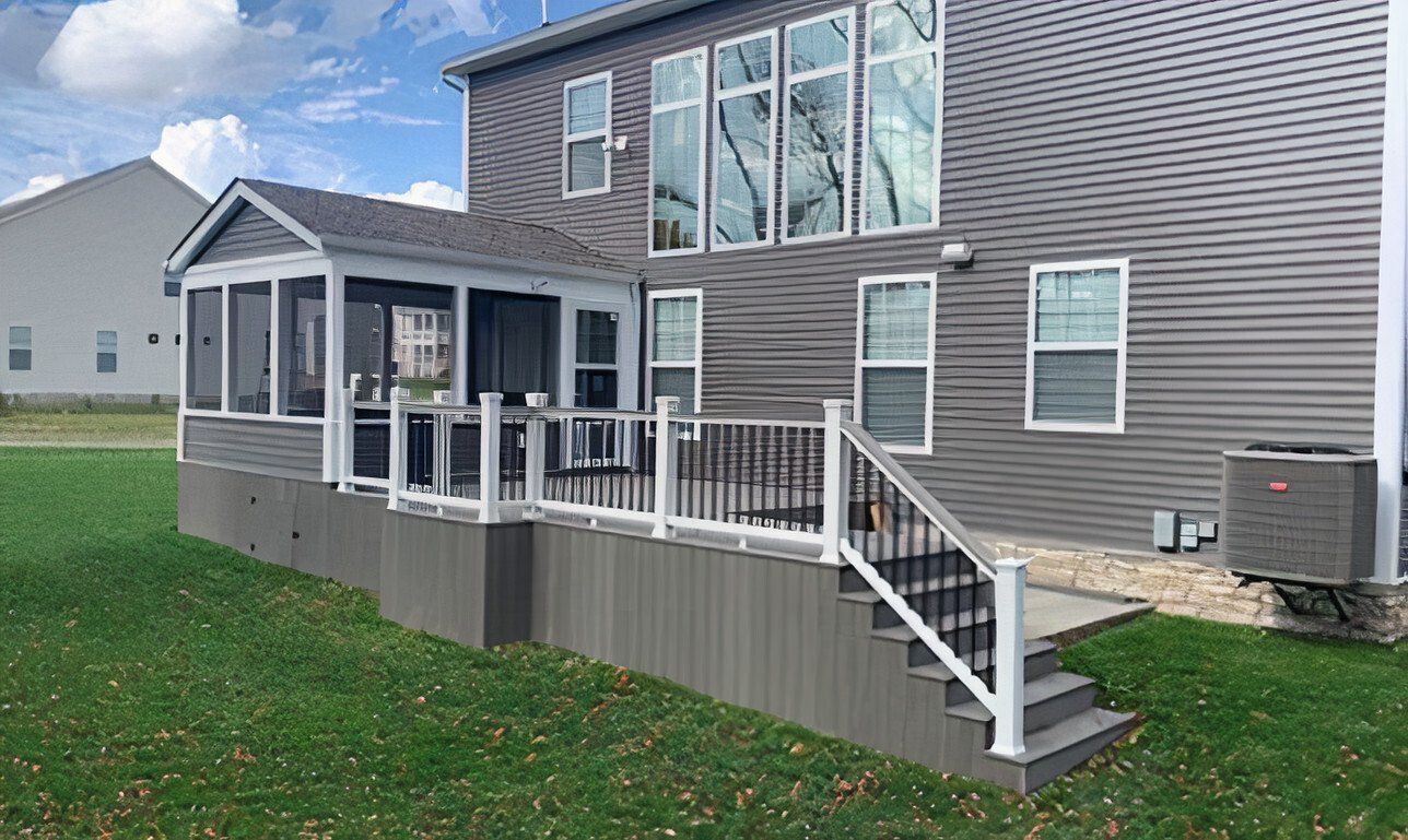 House exterior with a raised wooden deck and white railings on a grassy yard.