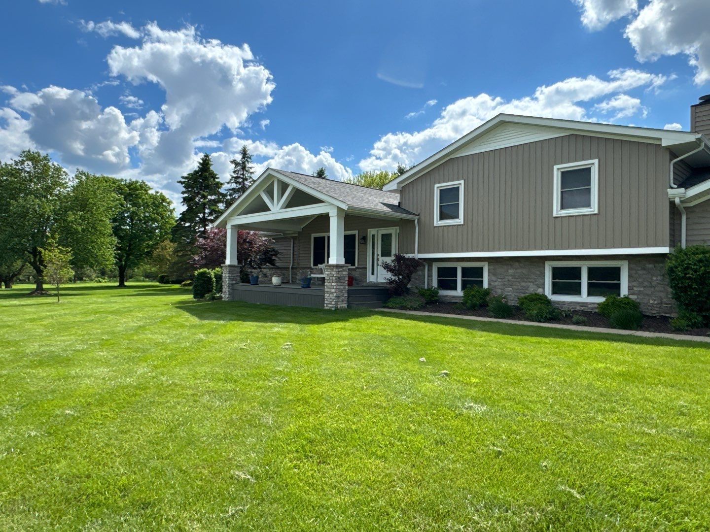 A large house with a large lawn in front of it.
