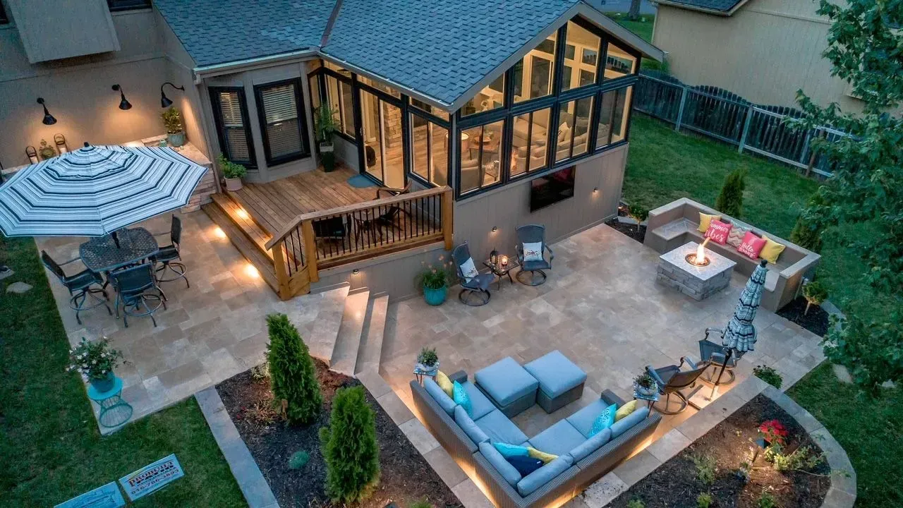 An aerial view of a backyard with a patio and a fire pit.
