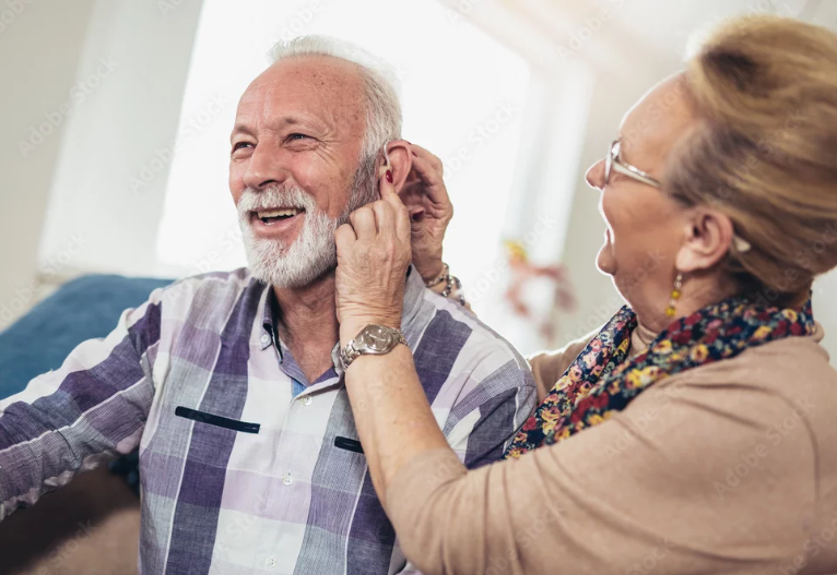 Doctor examining a patient’s ear with an otoscope in a clinic