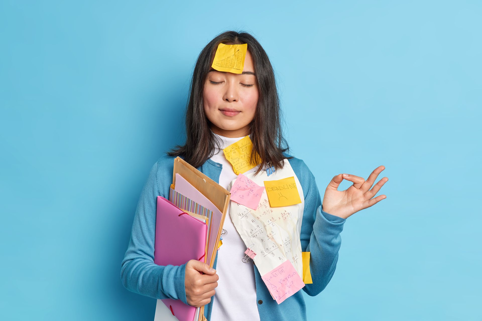 Woman with post-it notes, eyes closed, making an 