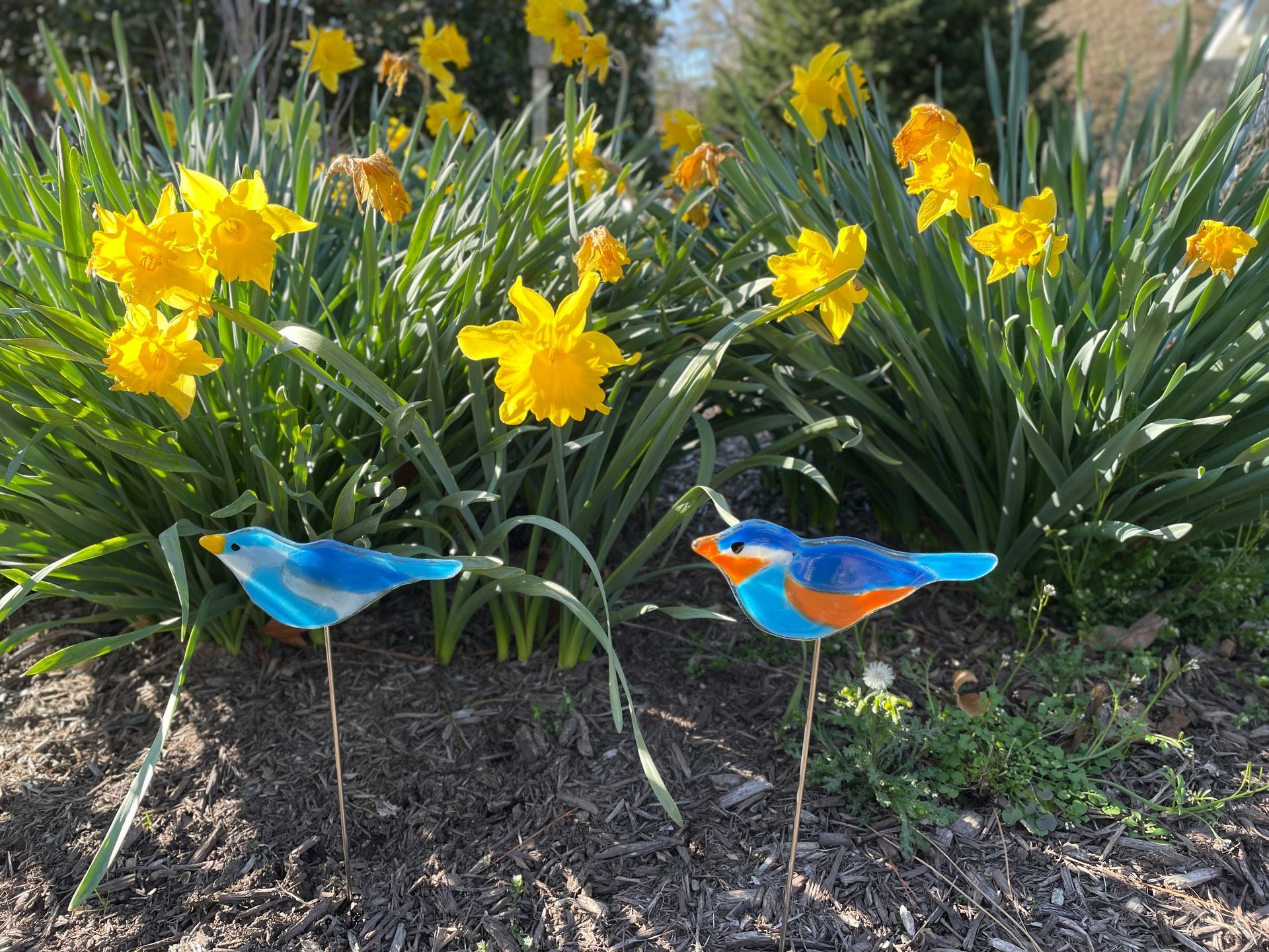 fused glass birds, blue birds in bed of yellow flowers