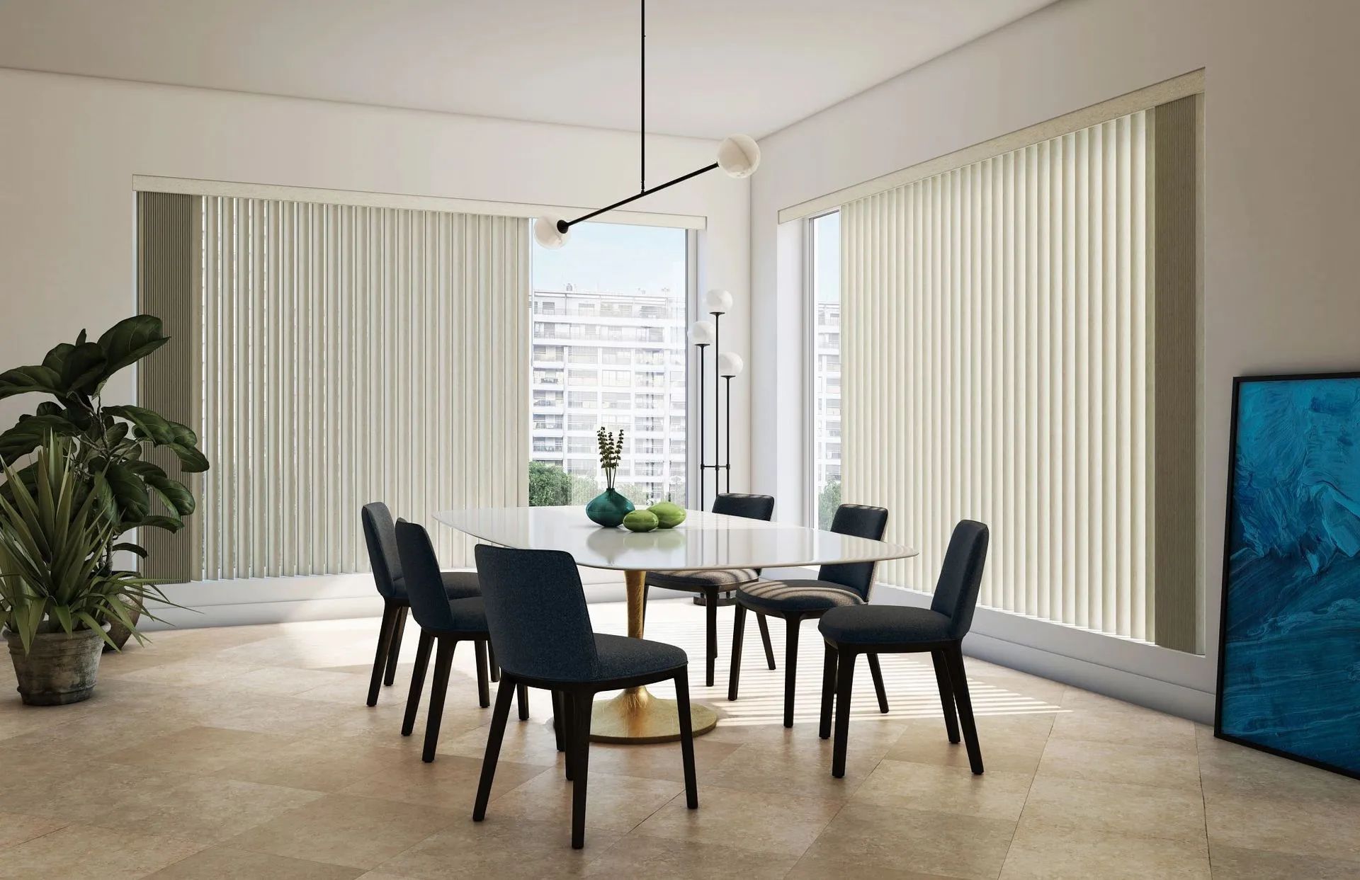 A dining room with a white table, six navy blue chairs, tall windows with vertical blinds, and a potted plant.