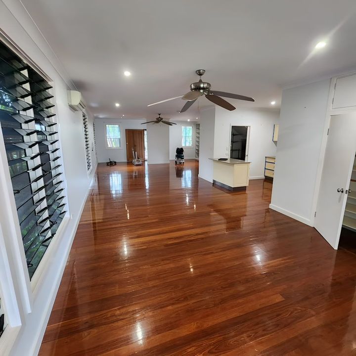 A living room with hardwood floors and a ceiling fan — ATM Floors in Townsville, QLD