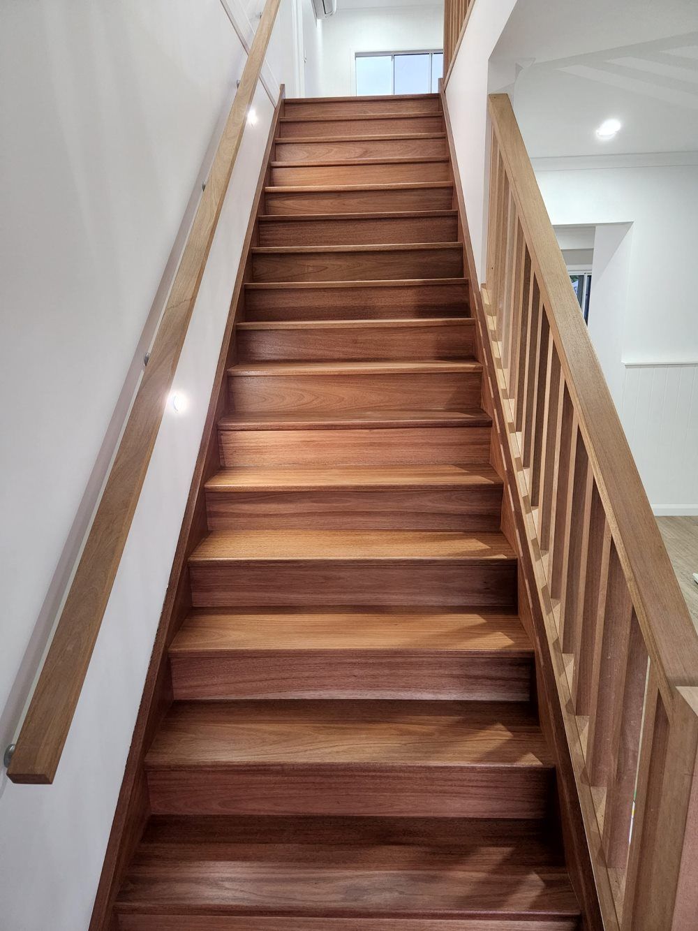 A Wooden Staircase Leading Up to the Second Floor of a House — ATM Floors In Mount Louisa, QLD