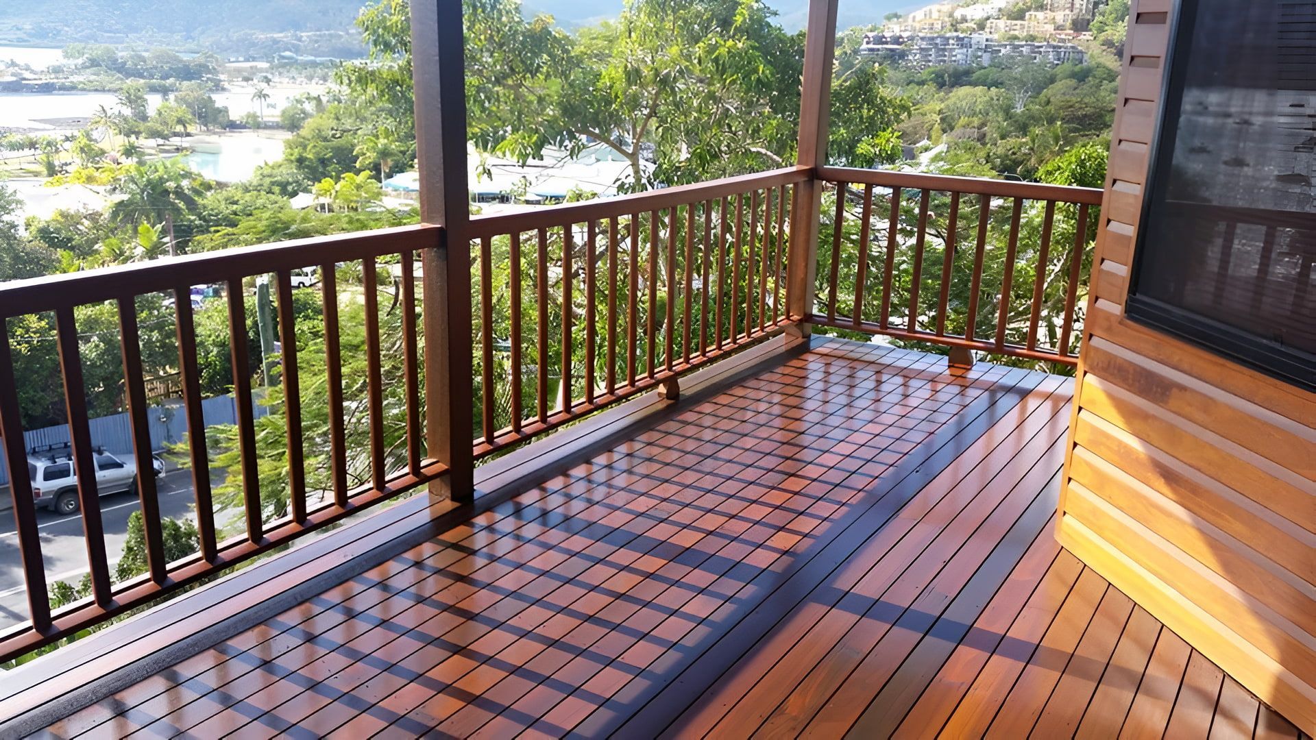 A Wooden Deck With a Railing Overlooking a Body of Water — ATM Floors In Mount Louisa, QLD