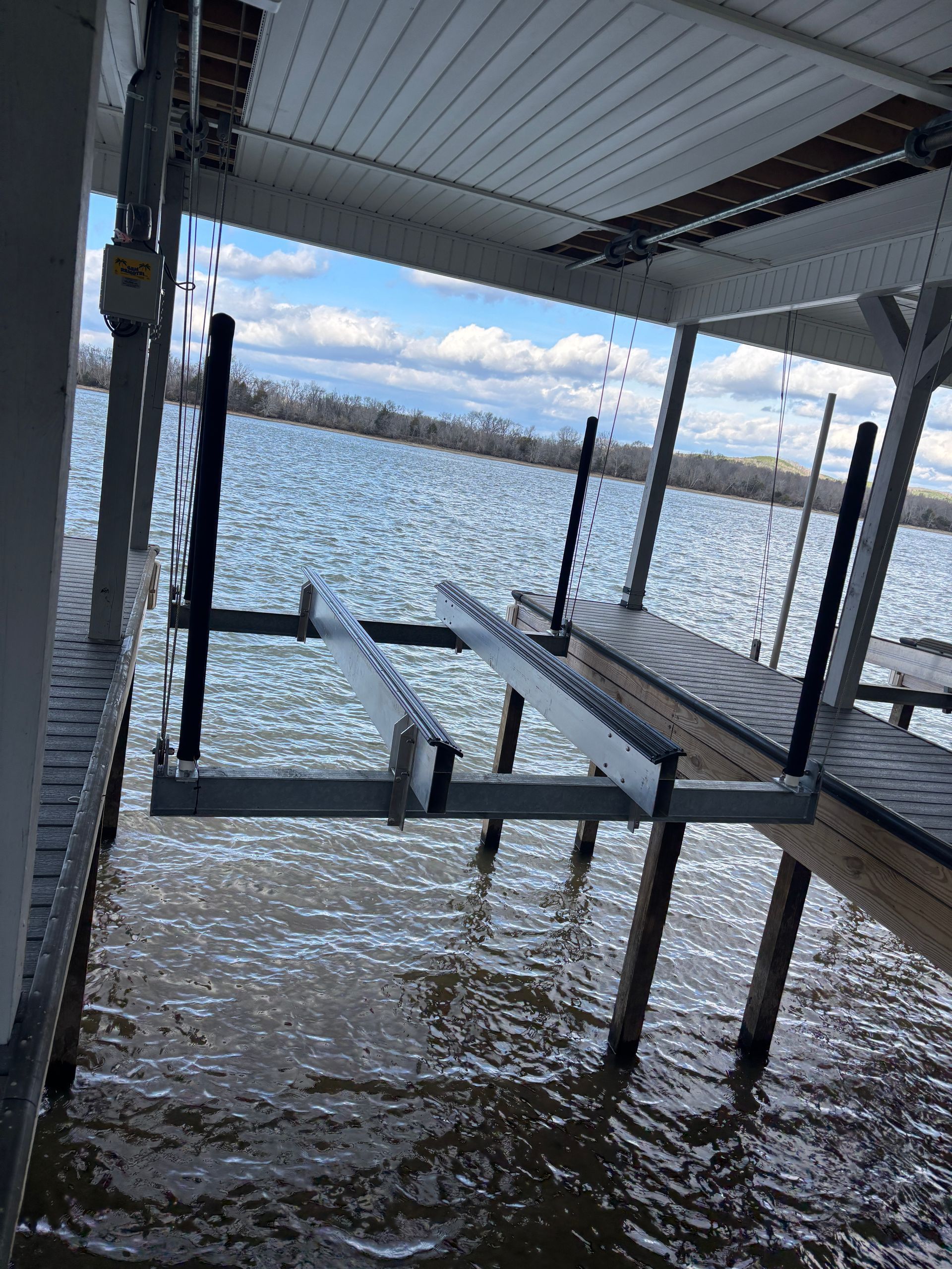 A dock is sitting in the middle of a body of water.