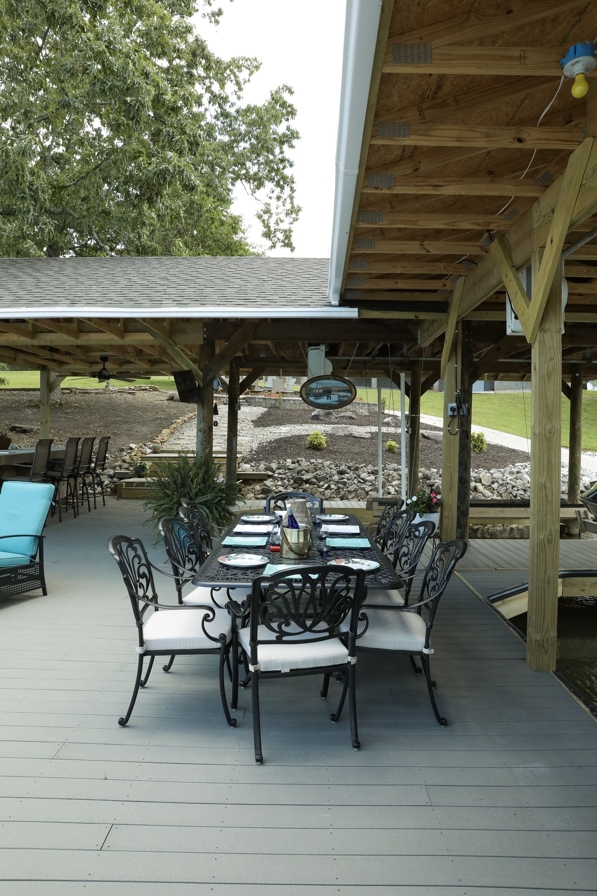 A patio with a table and chairs under a roof