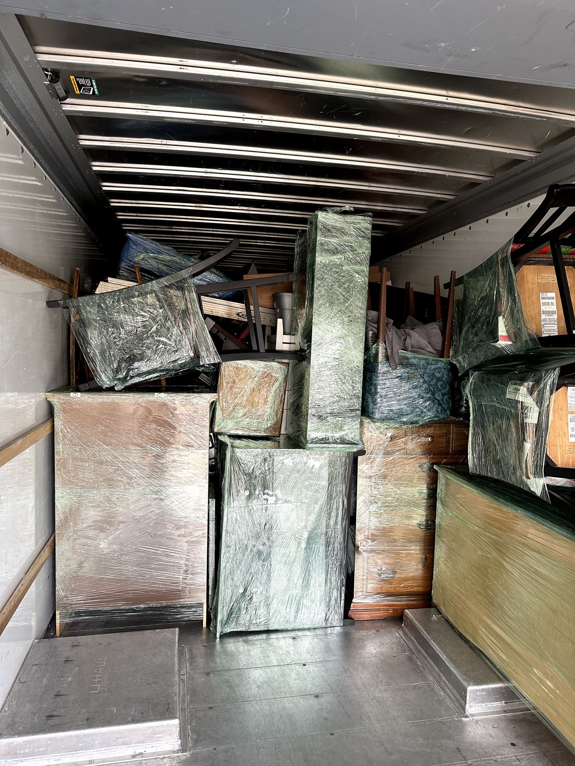 A truck filled with lots of furniture and boxes.