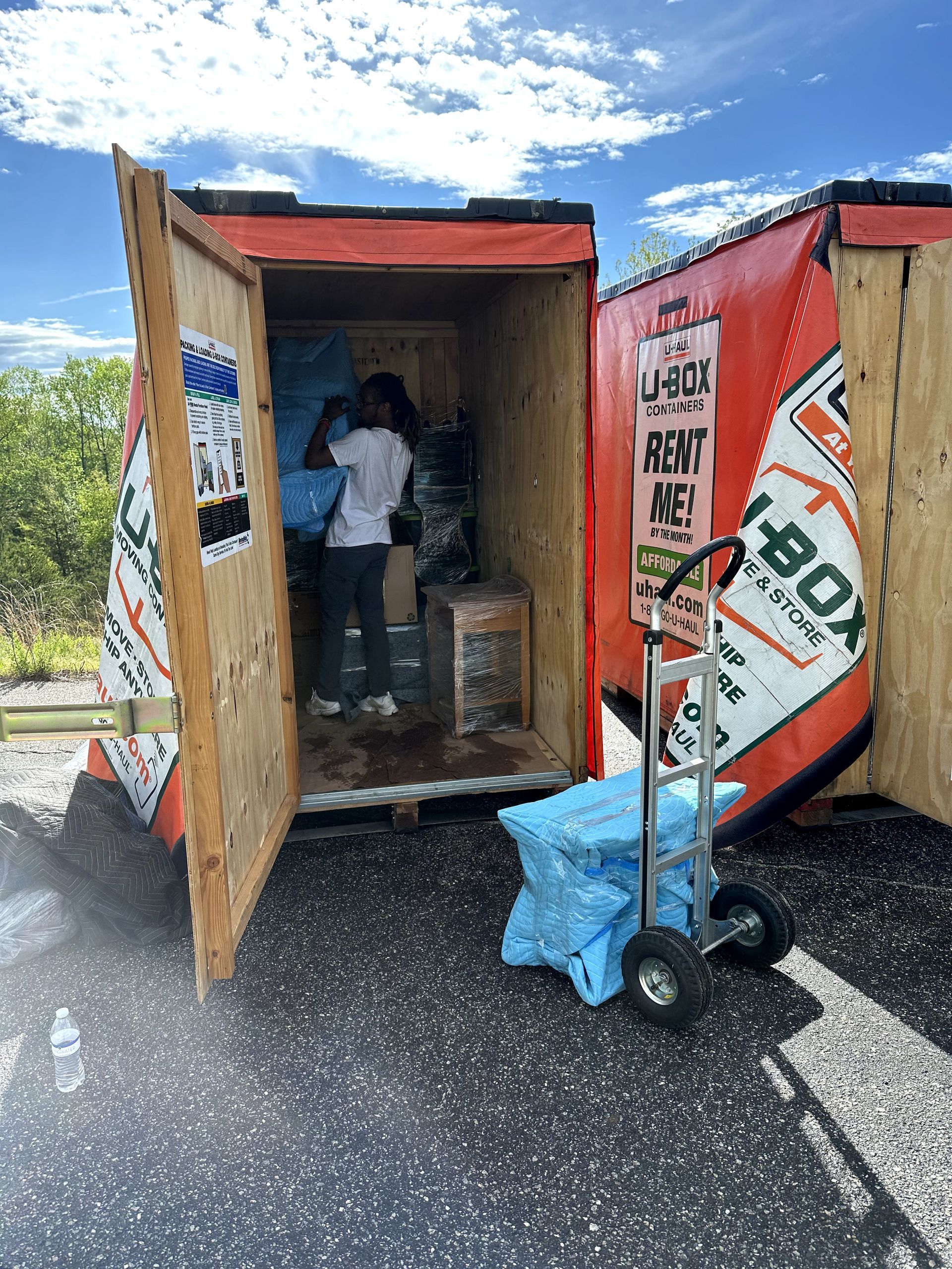 A man is standing inside of a moving box.