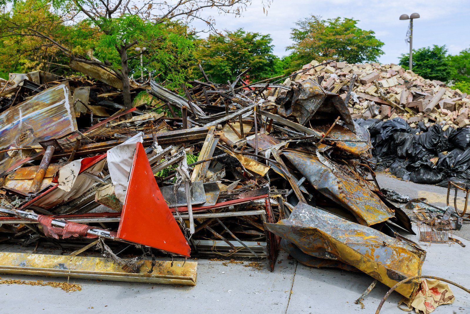 Debris from a fire; charred remains of what appears to be a building, with a red triangle visible.