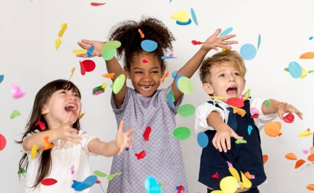 Children throwing confetti in the air.