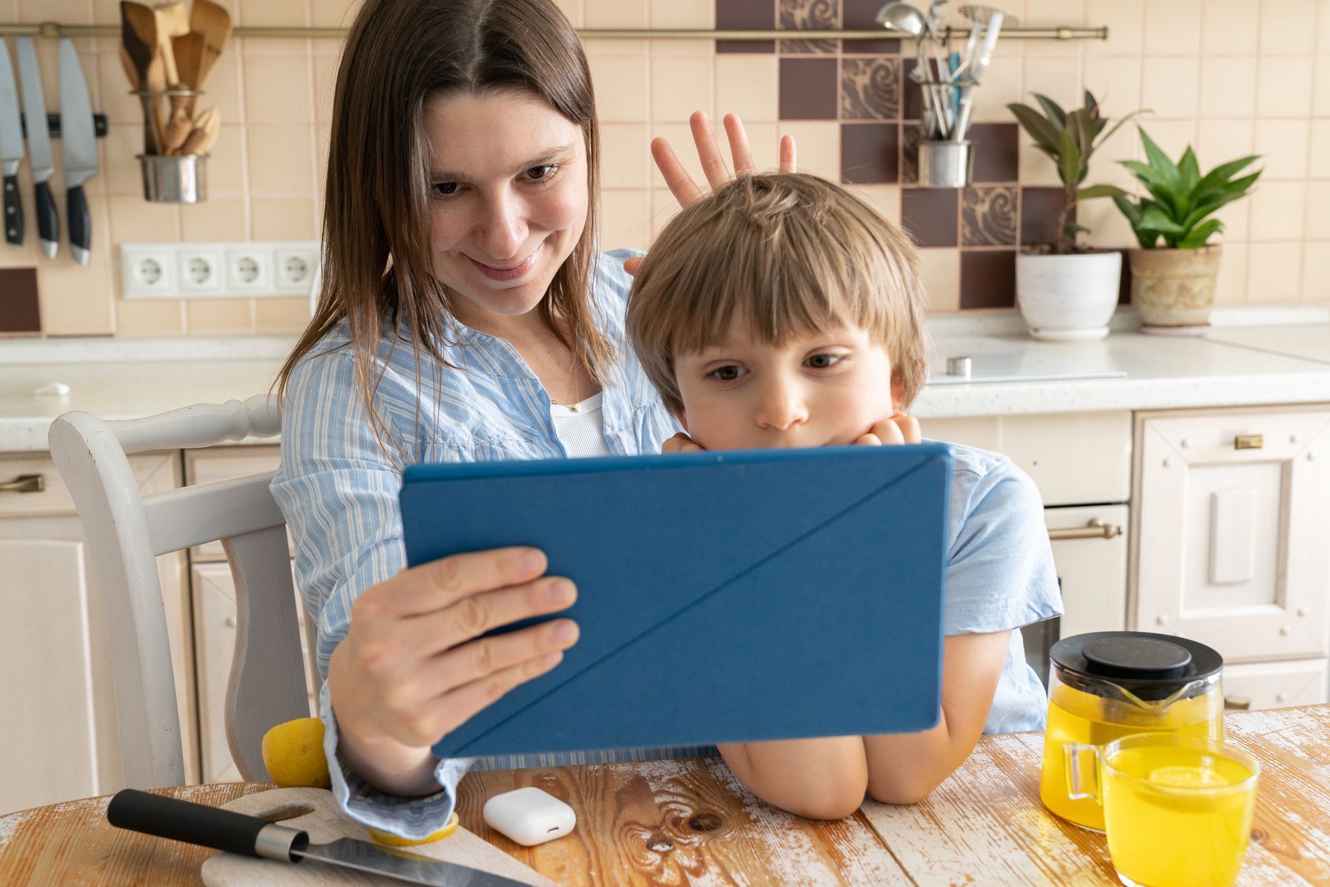 Parent reading to child on tablet.