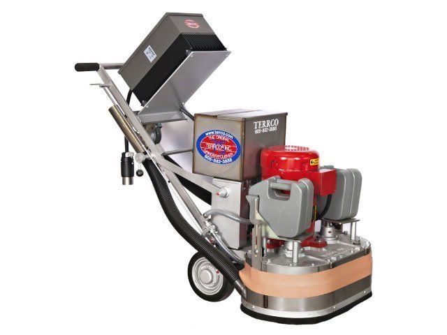 Industrial floor grinder with red engine and metal dust hopper, angled on wheels