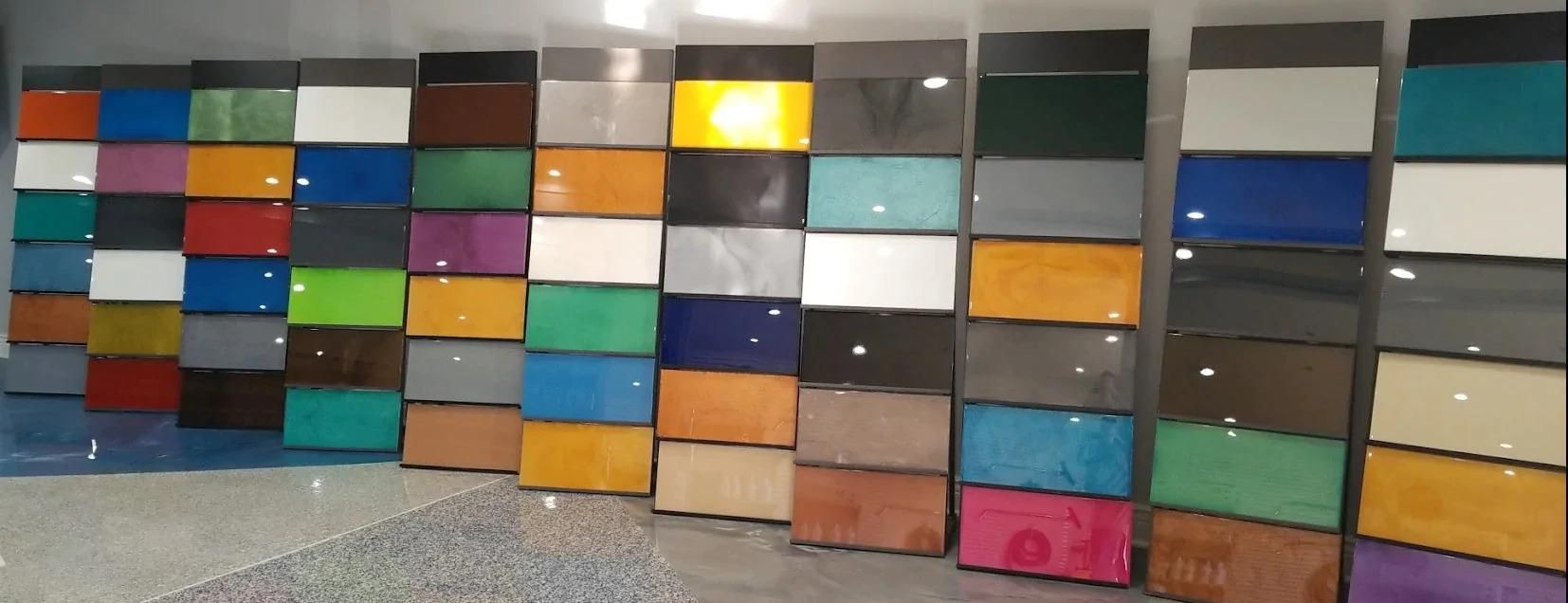 Colorful stacked drawers arranged in a row, each with different colored fronts and reflective tops.