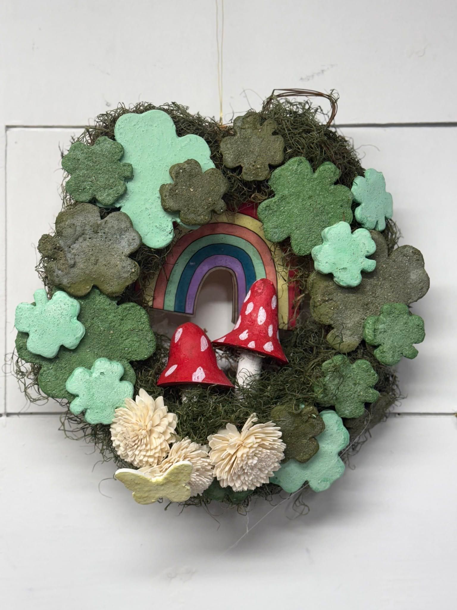 Mini mushroom wreath with moss, rainbow arch, and red-and-white toadstool ornaments