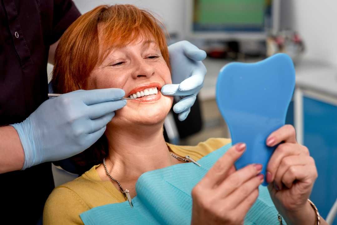 Clear dental mirror on a light blue background