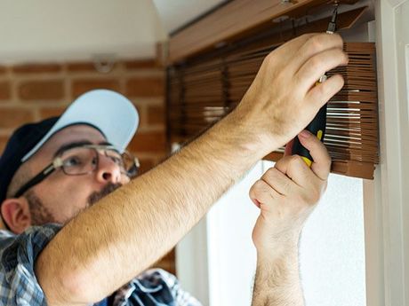 Man Fixing The Window Blind — San Diego, CA — Blind Speed-Sparkle Blinds Man Fixing The Window Blind — San Diego, CA — Blind Speed-Sparkle Blinds