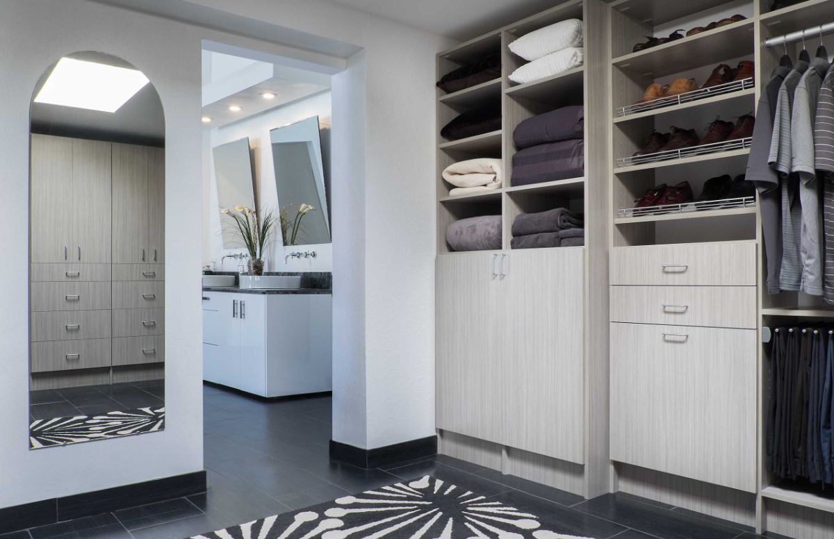 A walk in closet with a zebra print floor and a mirror.