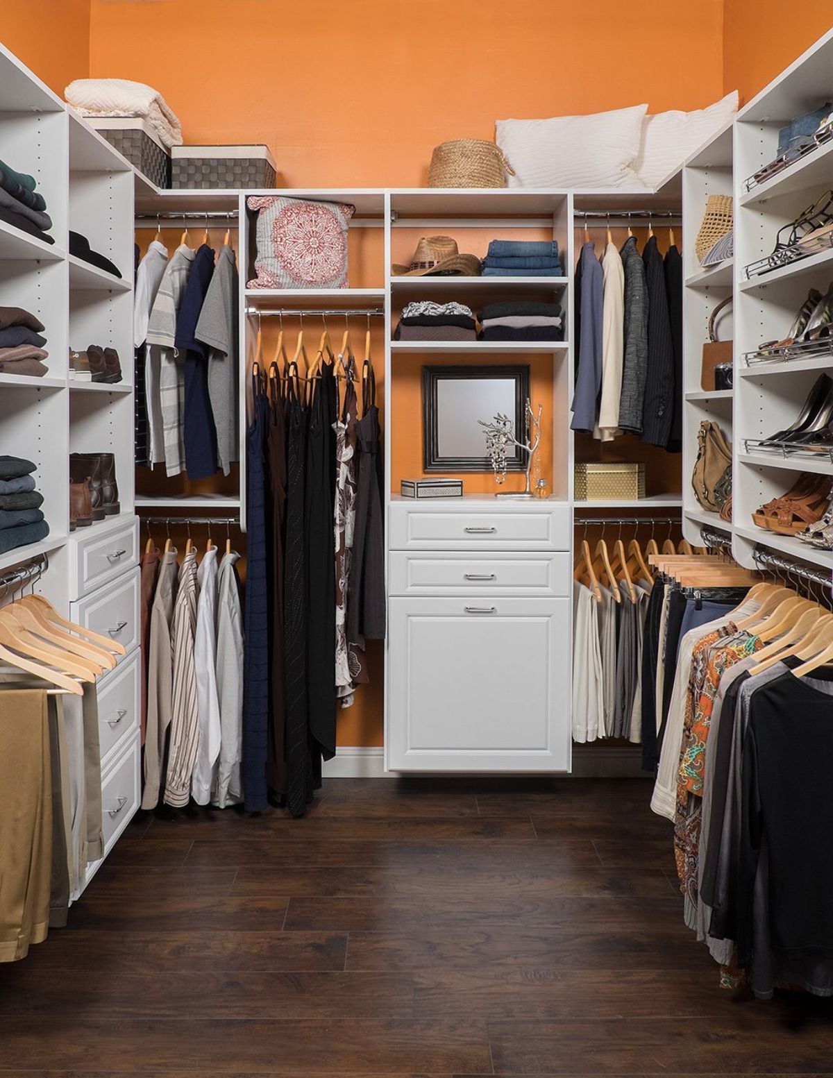A walk in closet filled with clothes and a mirror