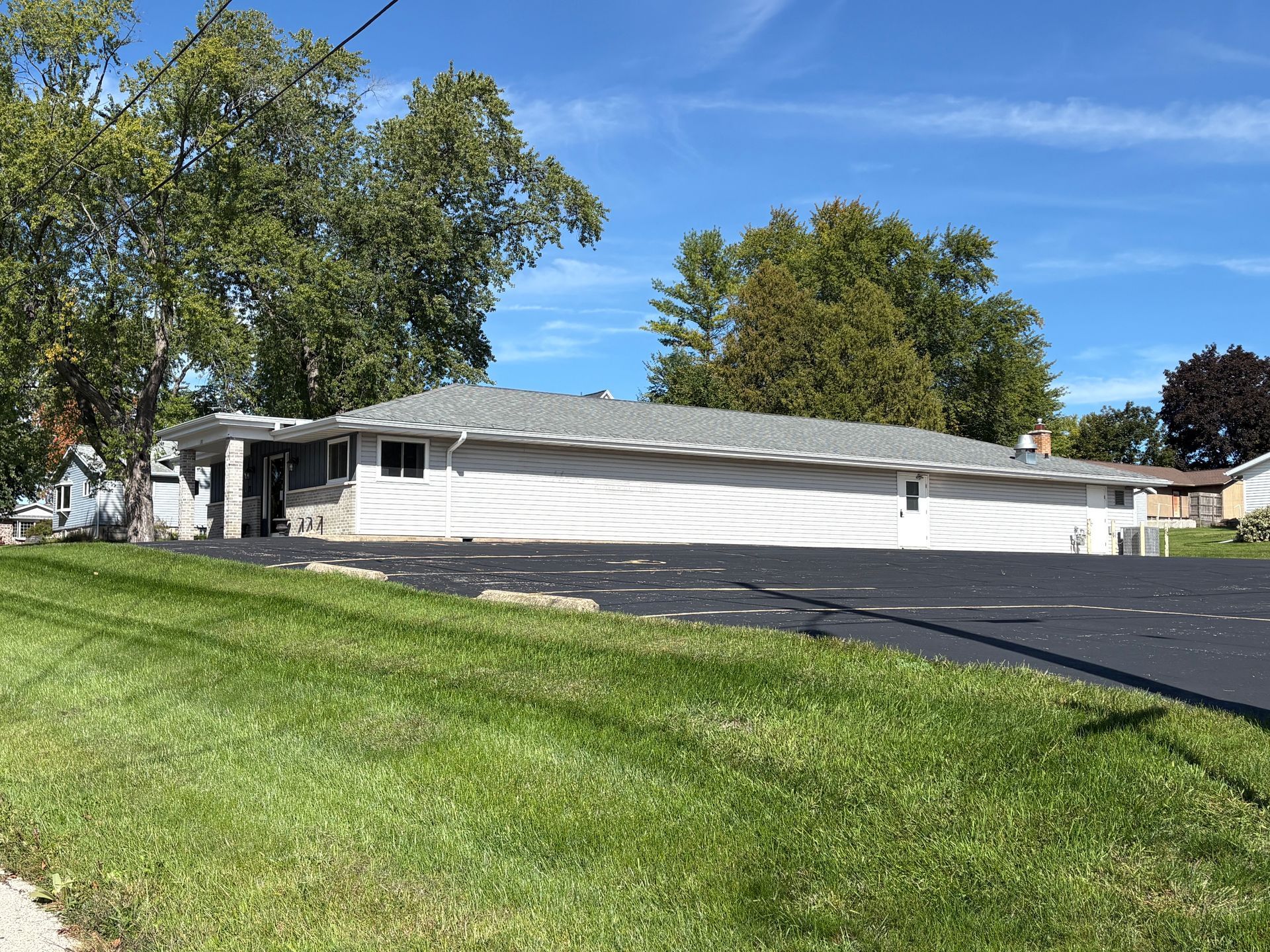 A large building with a curved roof is sitting on the side of the road.