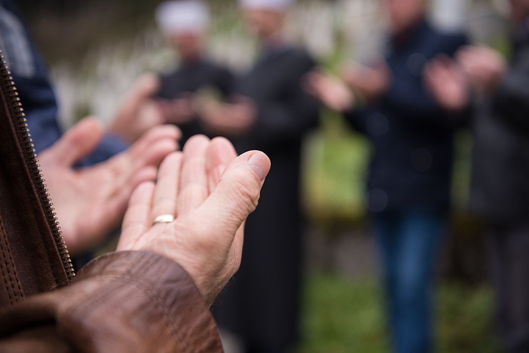 A group of people are clapping their hands in a circle.