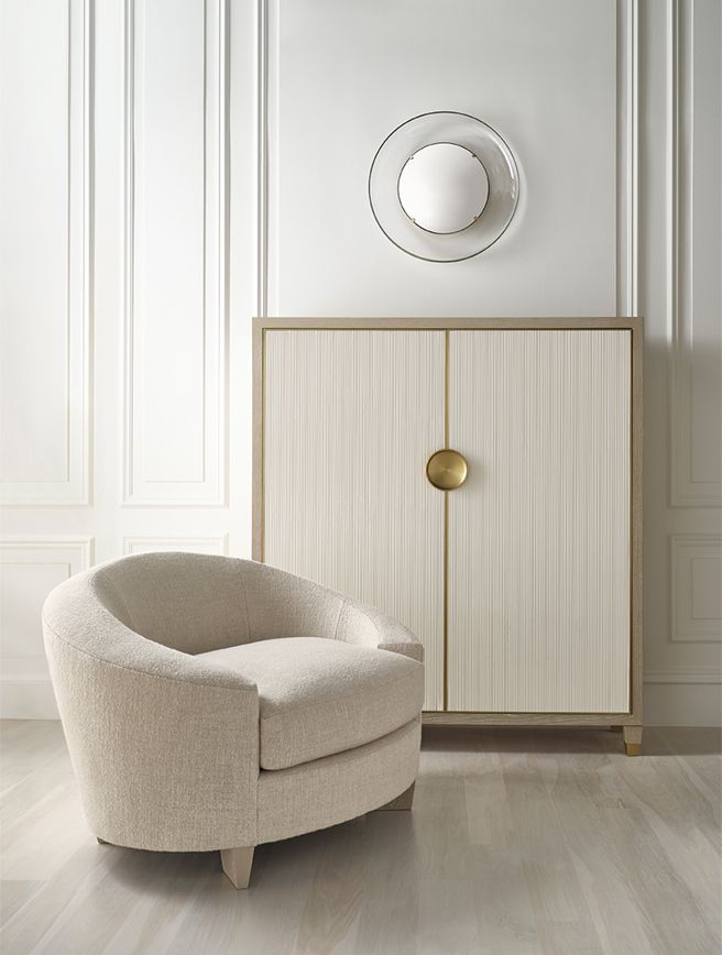 A chair is sitting next to a cabinet in a room.