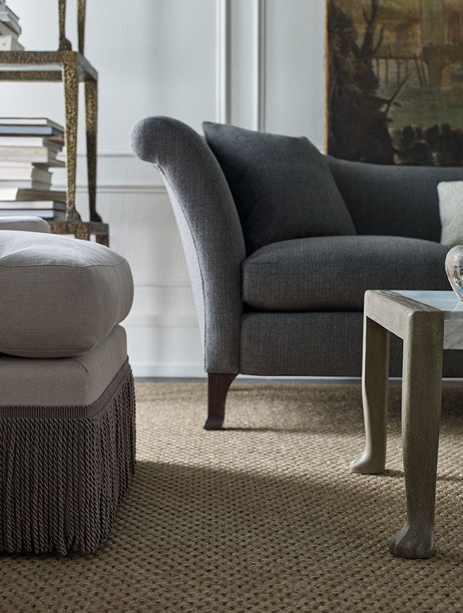 A living room with a couch ottoman and coffee table