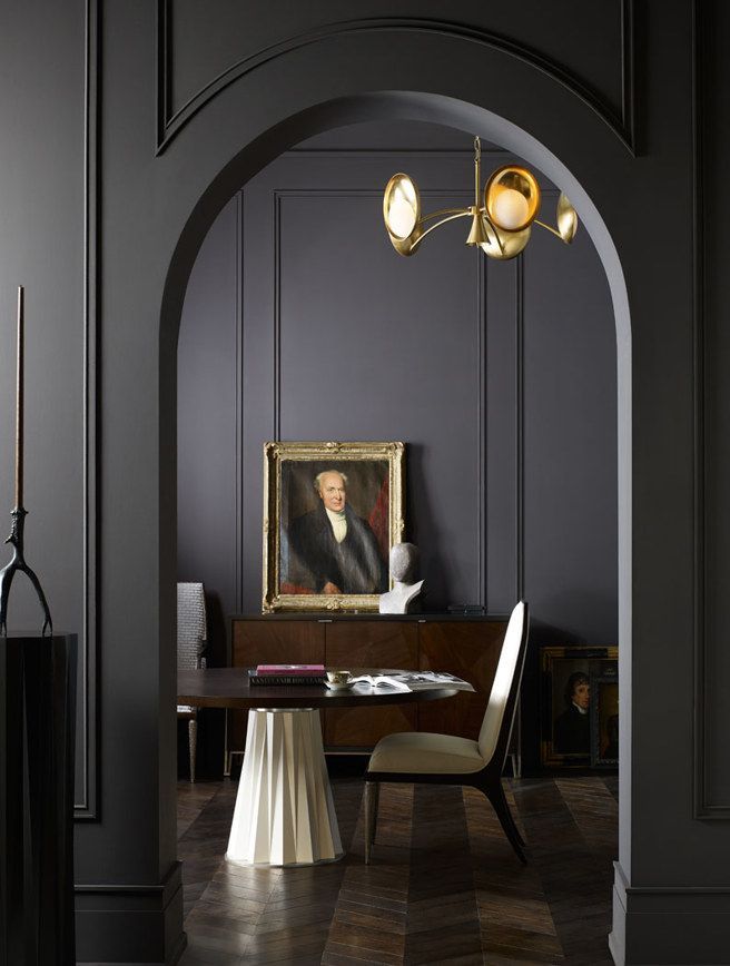 A dark room with a painting of a man on the wall