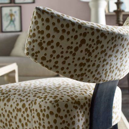 A chair with a leopard print on it in a living room