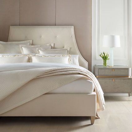 A bedroom with a bed , nightstand and lamp