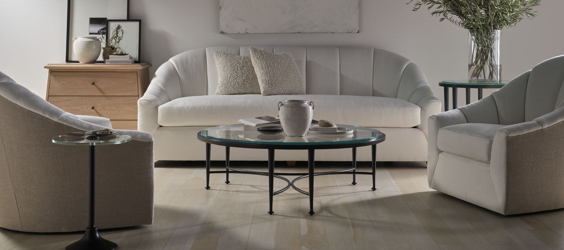 A living room with a couch , two chairs , and a coffee table.