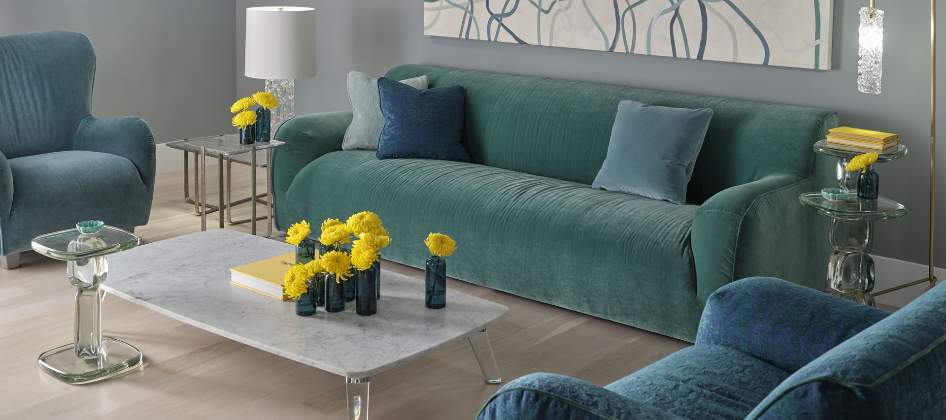 A living room with a green couch and blue chairs