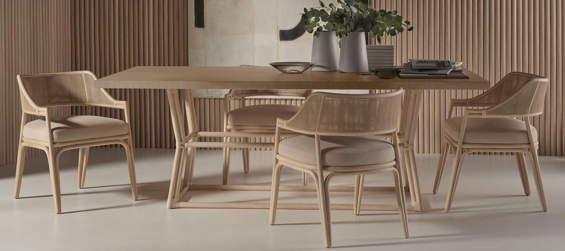 A wooden dining table and chairs in a room with a wooden wall.