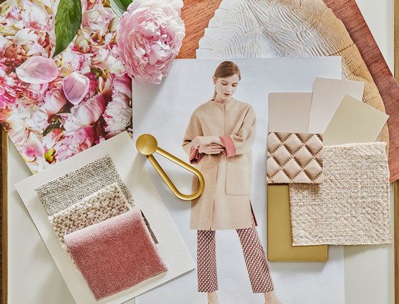 There is a picture of a woman surrounded by fabrics and flowers.
