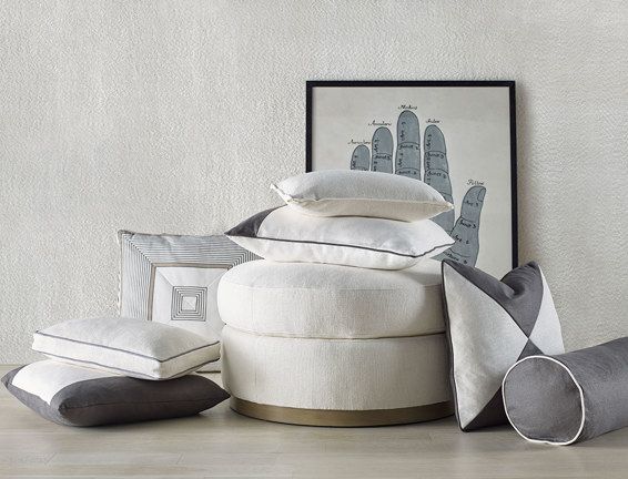 A bunch of pillows are stacked on top of each other on a table.