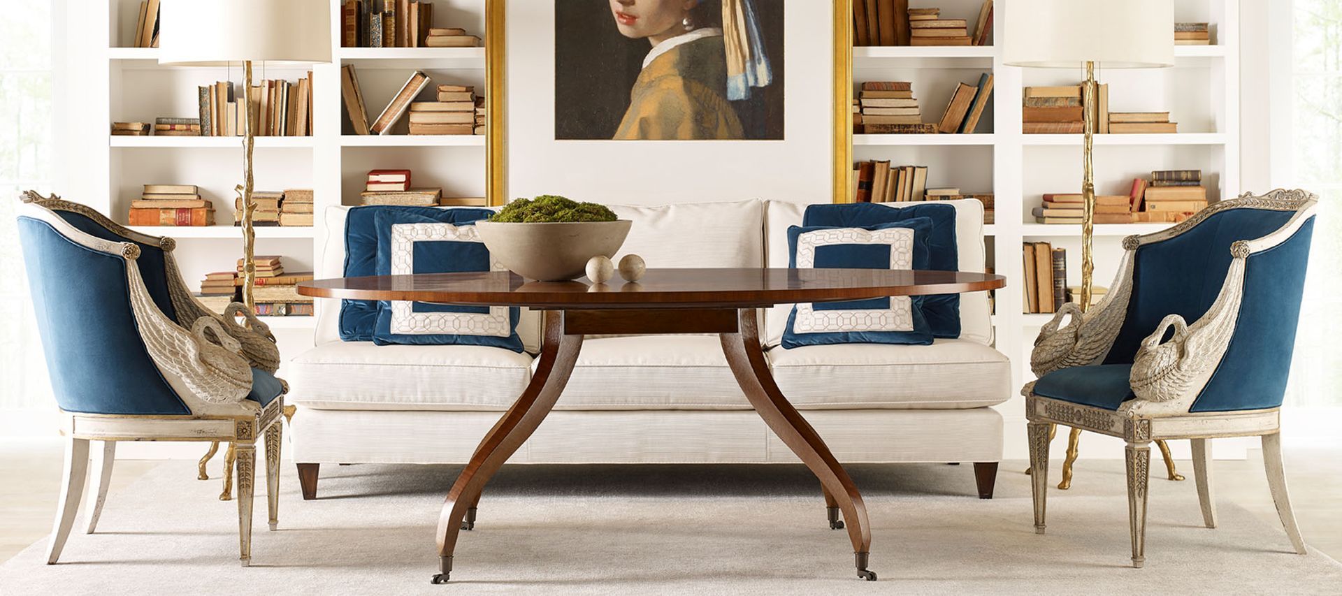 A living room with a table and chairs and a painting on the wall