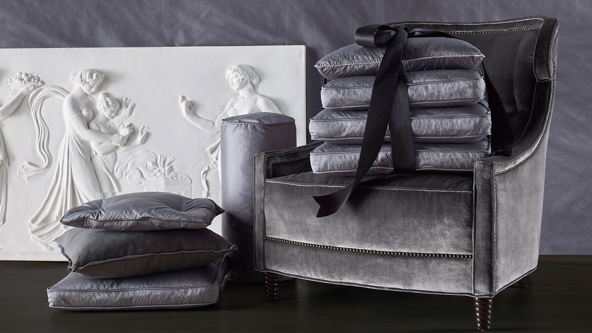 A couch with a stack of pillows on it