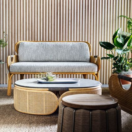 A living room with a couch , coffee table , and ottoman.