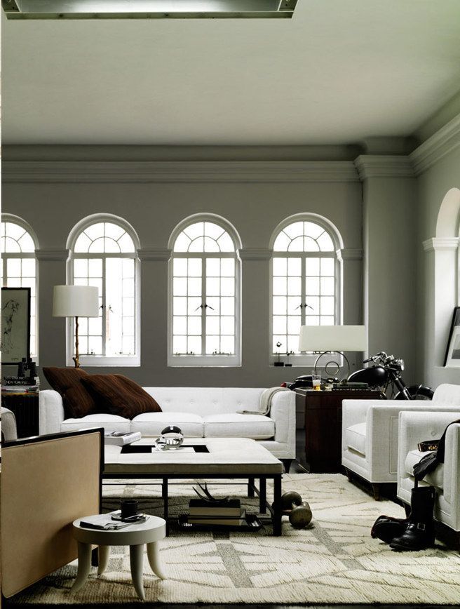 A living room with arched windows and a white couch