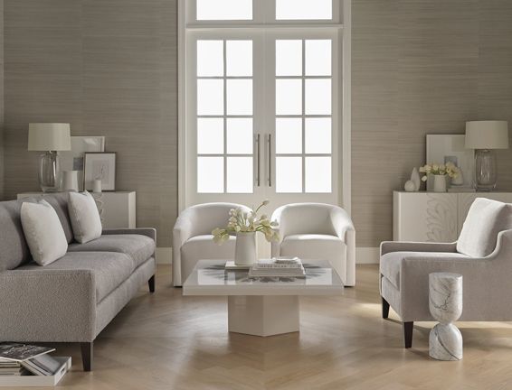 A living room with a couch , two chairs and a coffee table