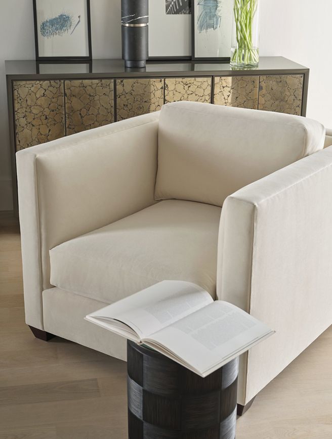 A chair with a book on a stool next to it