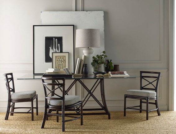 A room with a table and chairs and a lamp