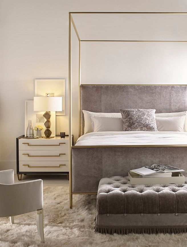 A bedroom with a canopy bed and a chair