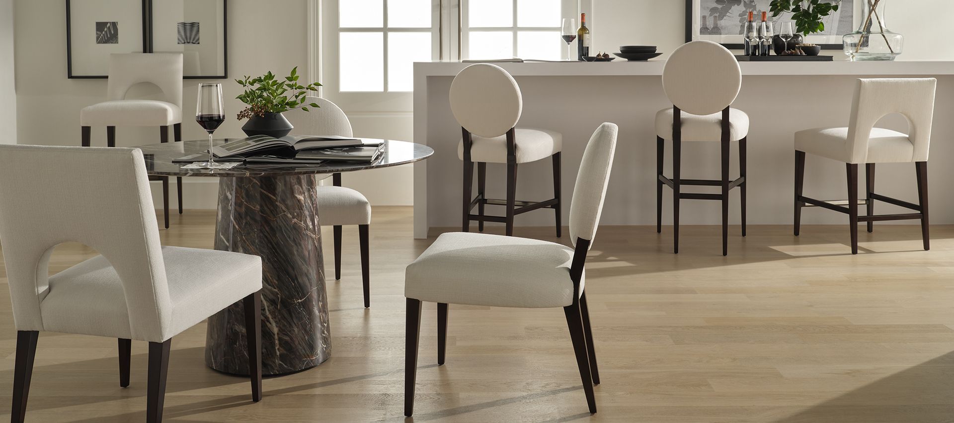 A dining room with a table and chairs and a bar.