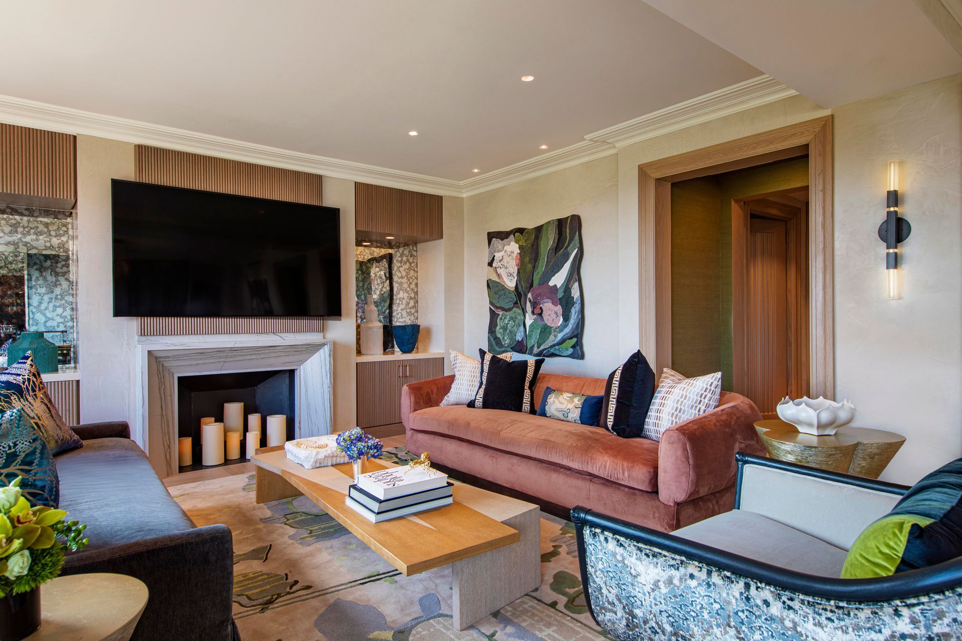 A living room with a couch , chair , coffee table and television.