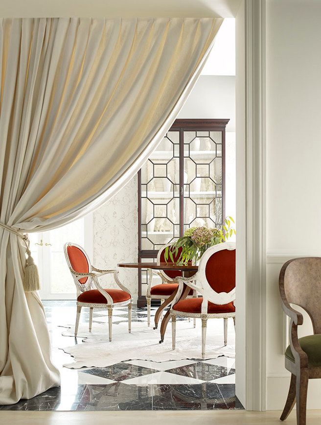 A living room with red chairs and a table