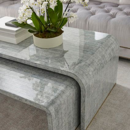 A coffee table with a vase of flowers on it